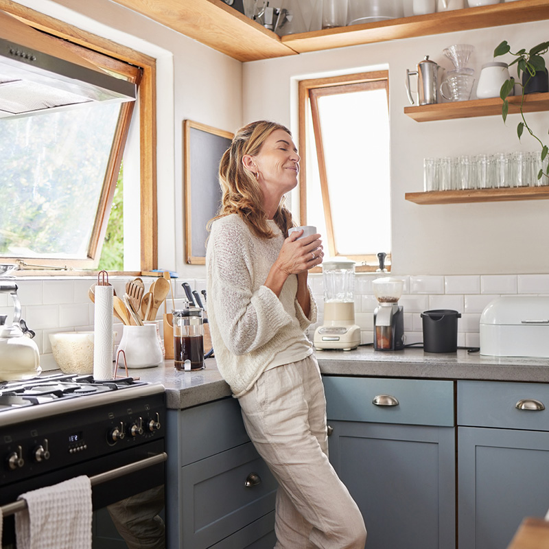 woman in kitchen with mug banner flipped square