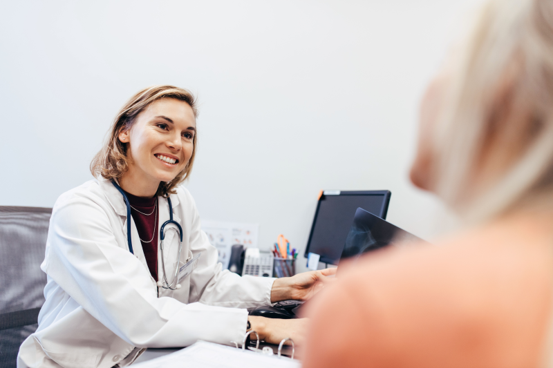 Female GP smiling at appointment