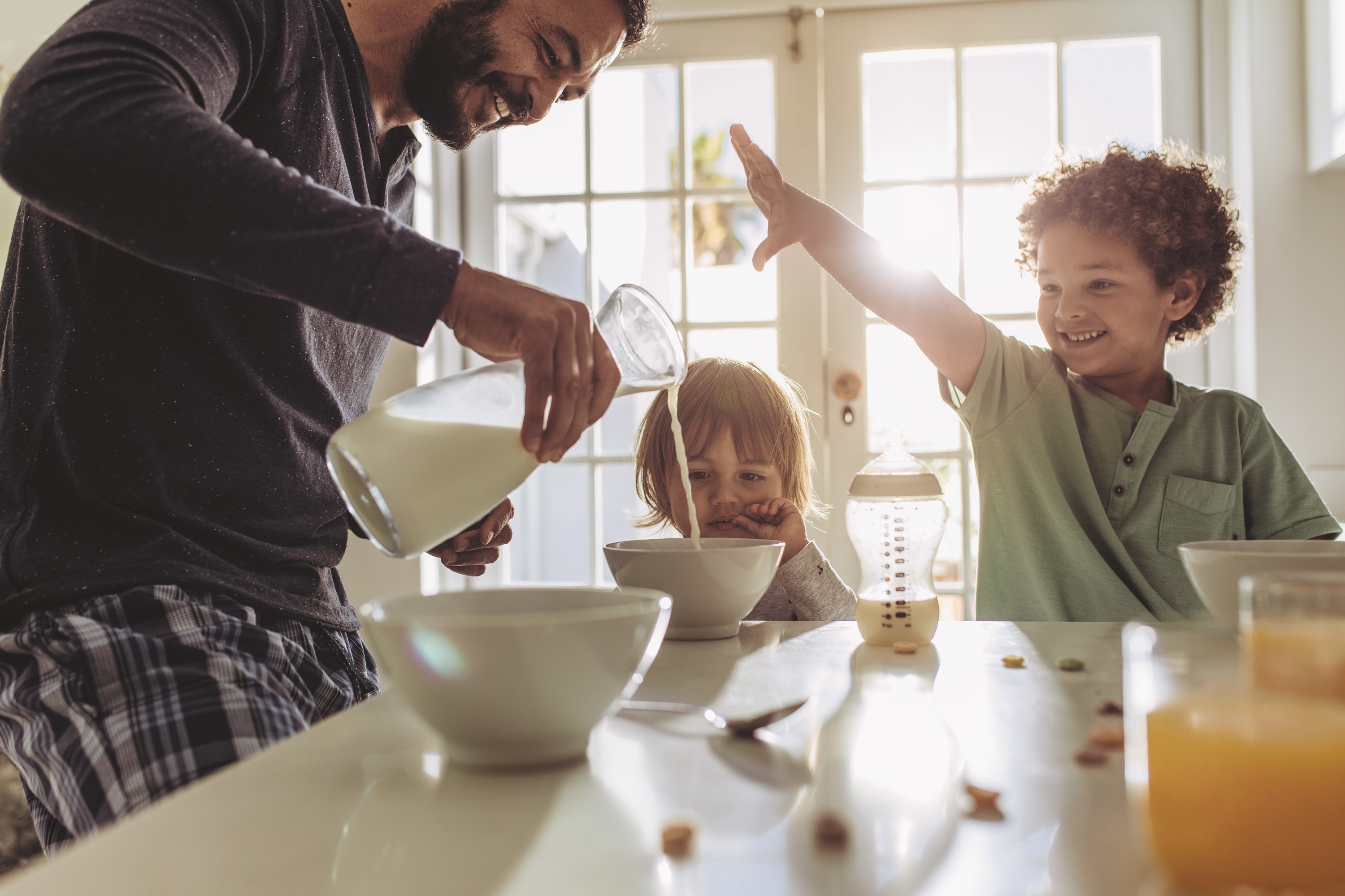 Young Family having a cheerful breakfast